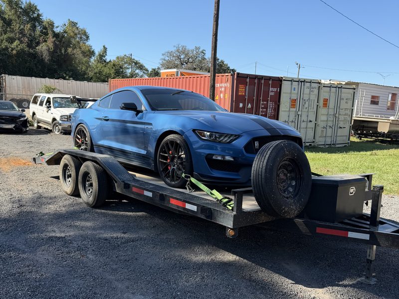 The 7 by 20 car hauler trailer with a sports car winched on and strapped down
