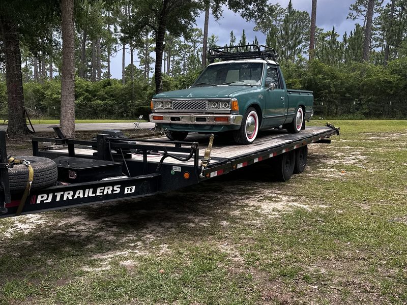 The 24 by 8.5 deckover tilt trailer with a pickup truck loaded on the deck
