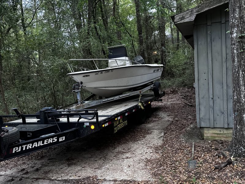 A center console boat loaded on the deckover trailer